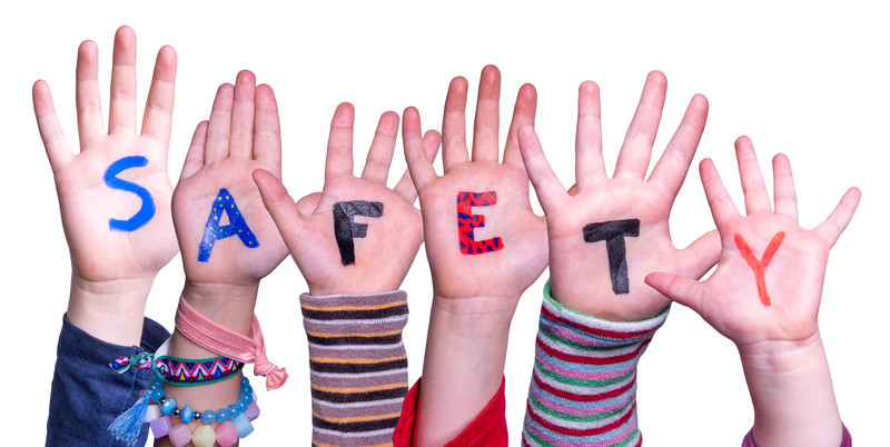 child safety tips: the word safety spelled out on palms of children's hands