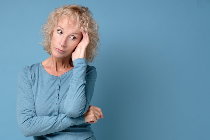 single mom at 60: older woman in blue shirt giving side eye