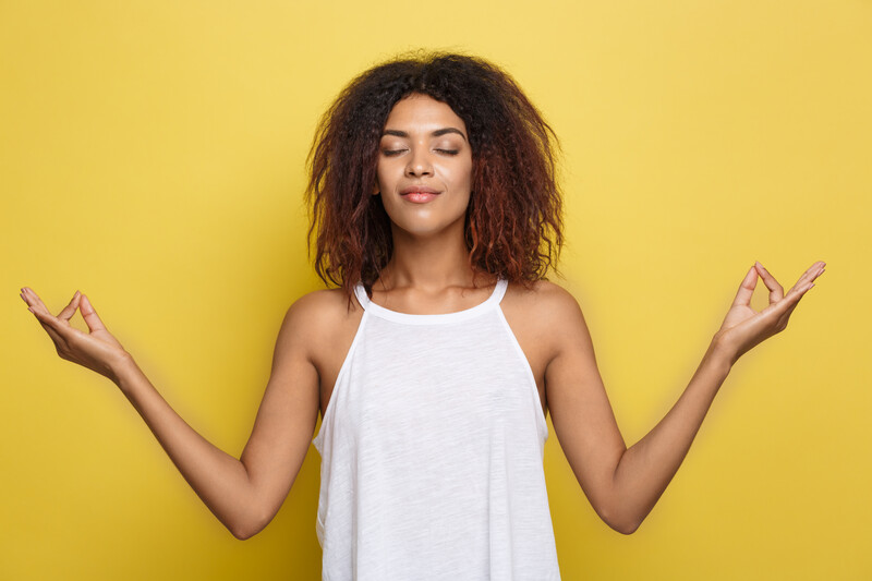 calm, relaxed african american woman meditating