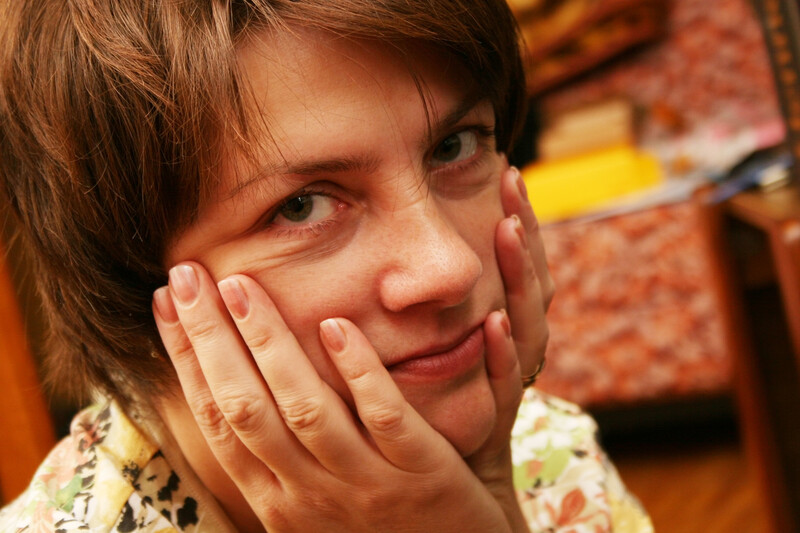 compassionate woman holding face in her hands