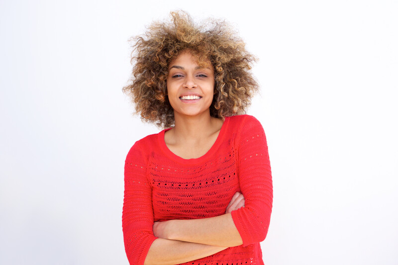 courageous black woman in red sweater with arms crossed