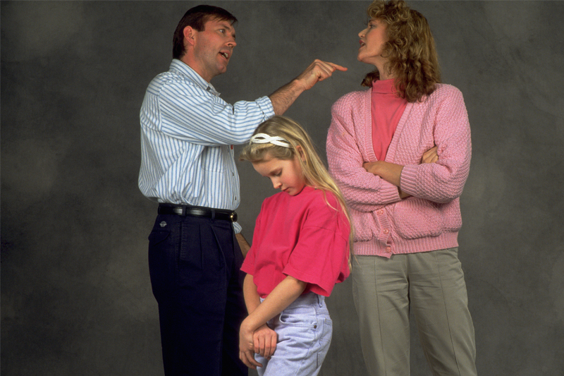 man and woman arguing over a child