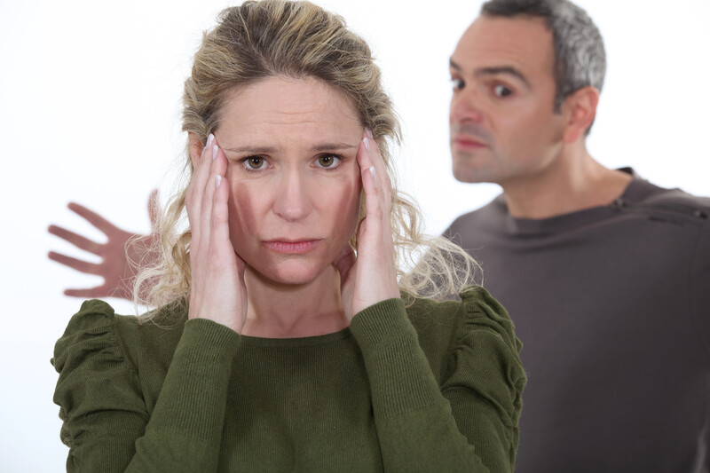 Man yelling behind upset woman