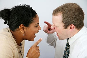 couple yelling an pointing fingers at each other