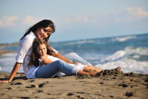 post-divorce summer vacation mom and daughter on beach