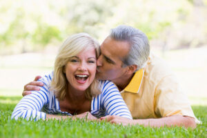 mature couple kissing in a park