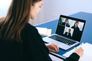 woman sits in front of laptop and has a virtual conference with a divorce lawyer