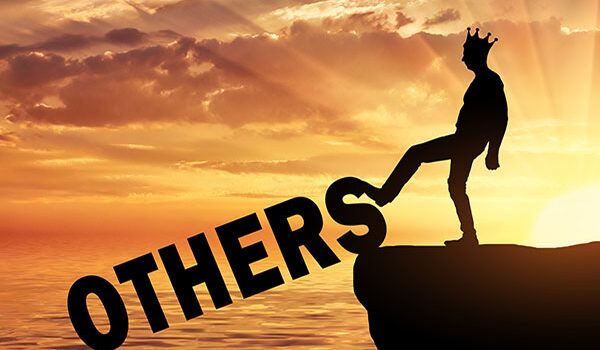 Negotiating with a Narcissist: silhouette of man wearing crown kicks the word "others" off a cliff