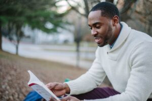 perfect life after divorce: man reading a book while dealing with the uncertainty of divorce