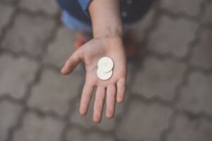 covered by child support: coins in child's hand