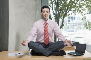 Mindfulness-Based Stress Reduction: lawyer meditating on desk