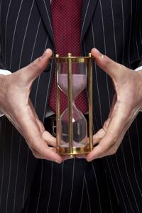 time management tips for family lawyers: lawyer holding an hourglass