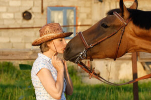 Make Mental & Emotional Wellness a Priority: woman kissing her horse