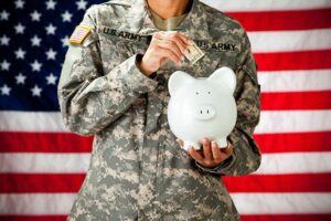 pre-marital service years: : female soldier deposits cash in piggybank for retirement