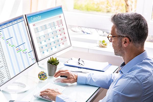 end-of-day ritual: man looking at calendar on screen